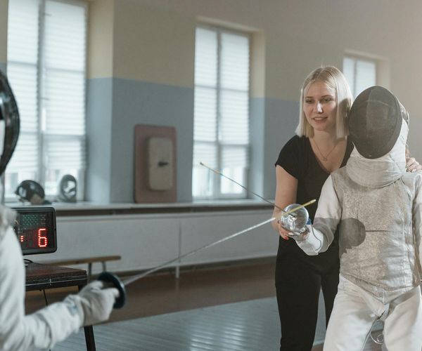 A coach observing a client's form during an exercise.